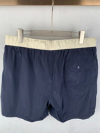 Moncler navy shorts-style pants with off-white waistband and front pocket detail