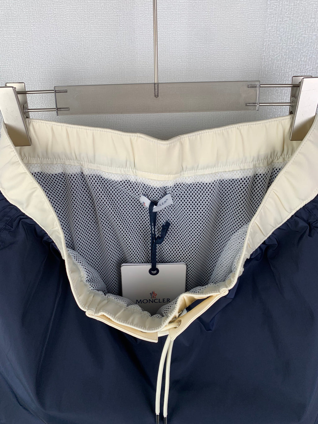 Moncler navy pants interior with mesh lining and off-white drawstring tie