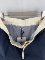Moncler navy pants interior with mesh lining and off-white drawstring tie
