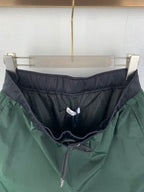 Moncler pants in green with dark inner lining, mesh panel waistband, drawstring