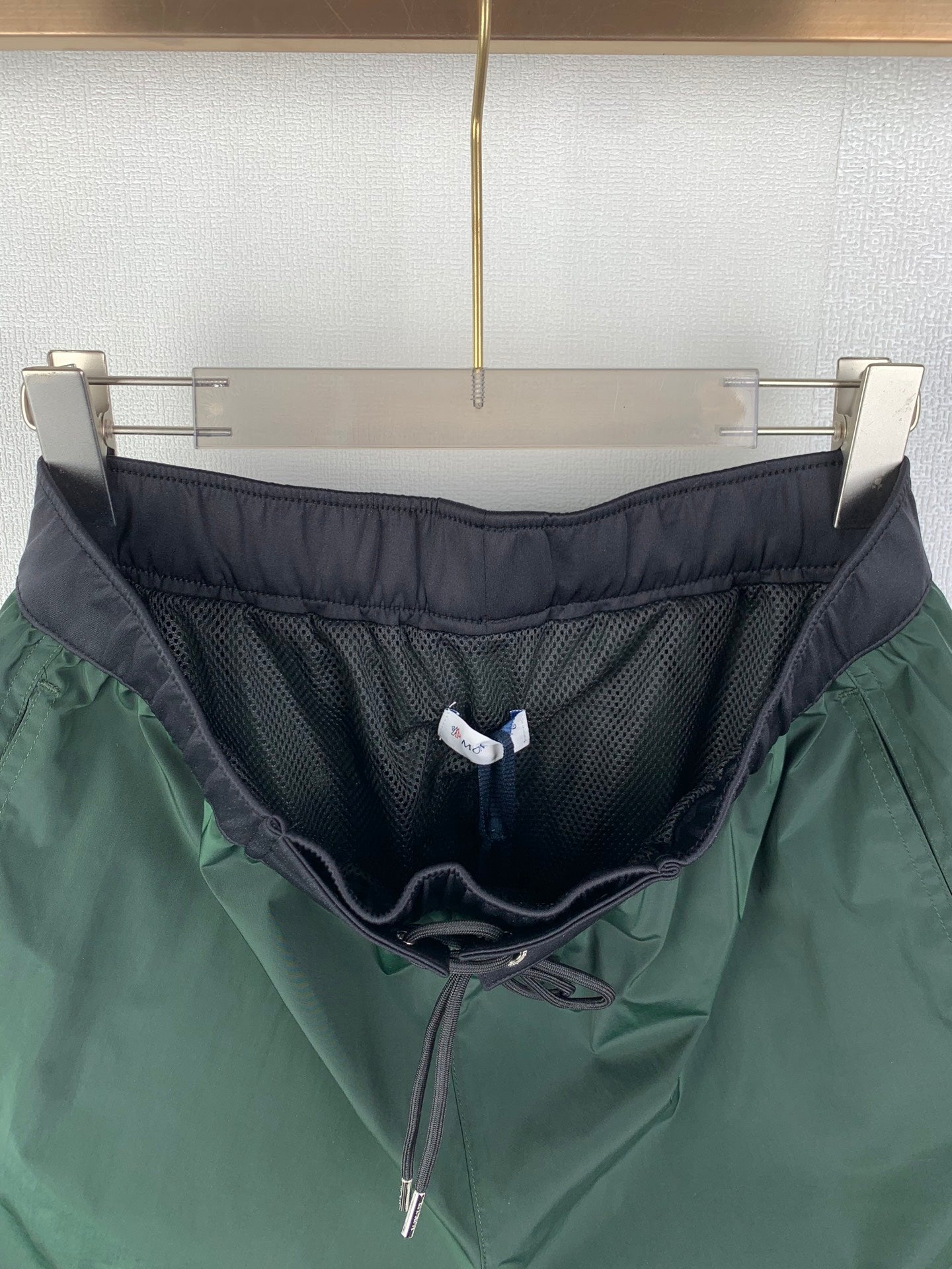Moncler pants in green with dark inner lining, mesh panel waistband, drawstring