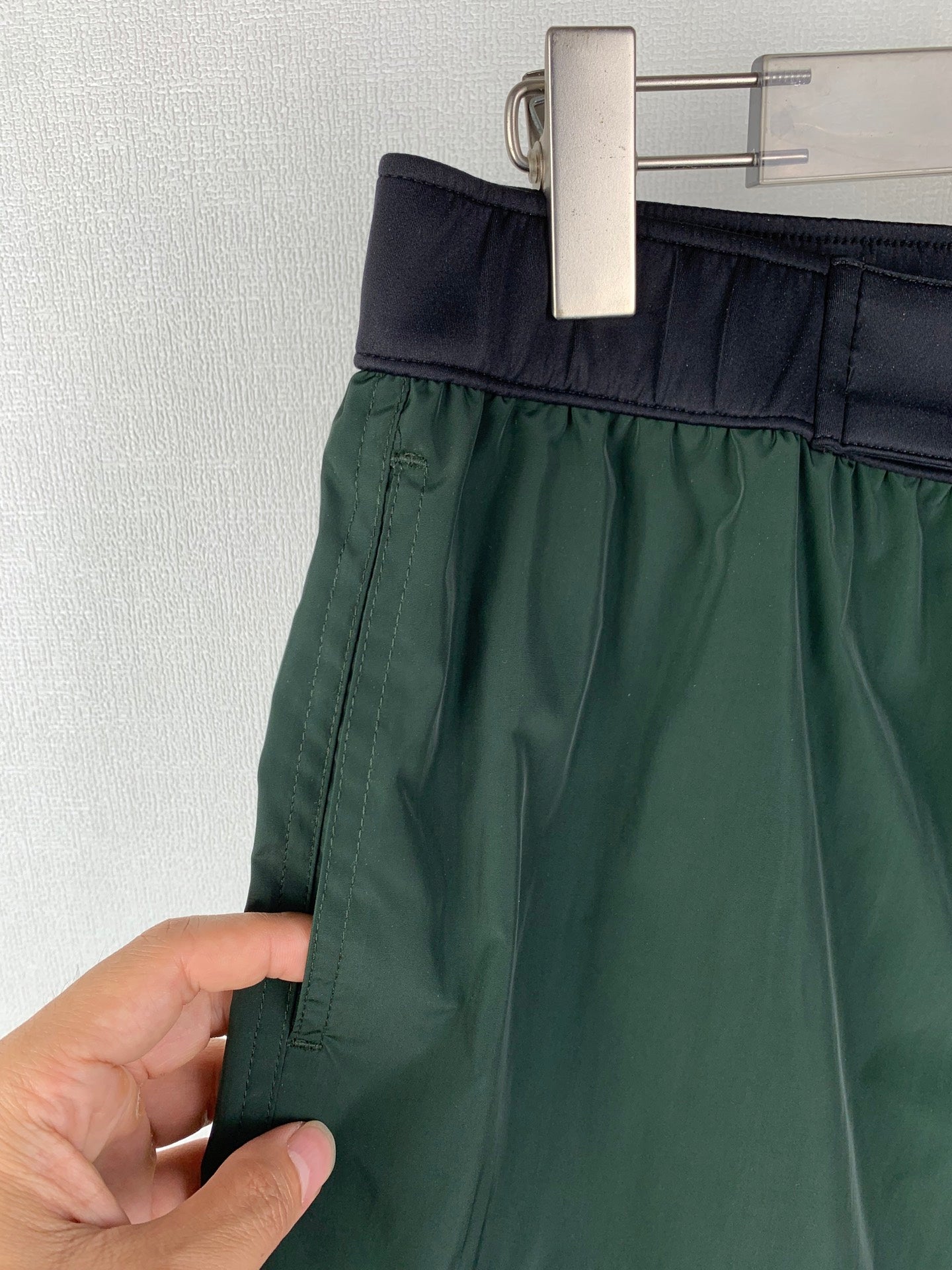 Moncler green shorts with dark elastic waistband and side seam stitching