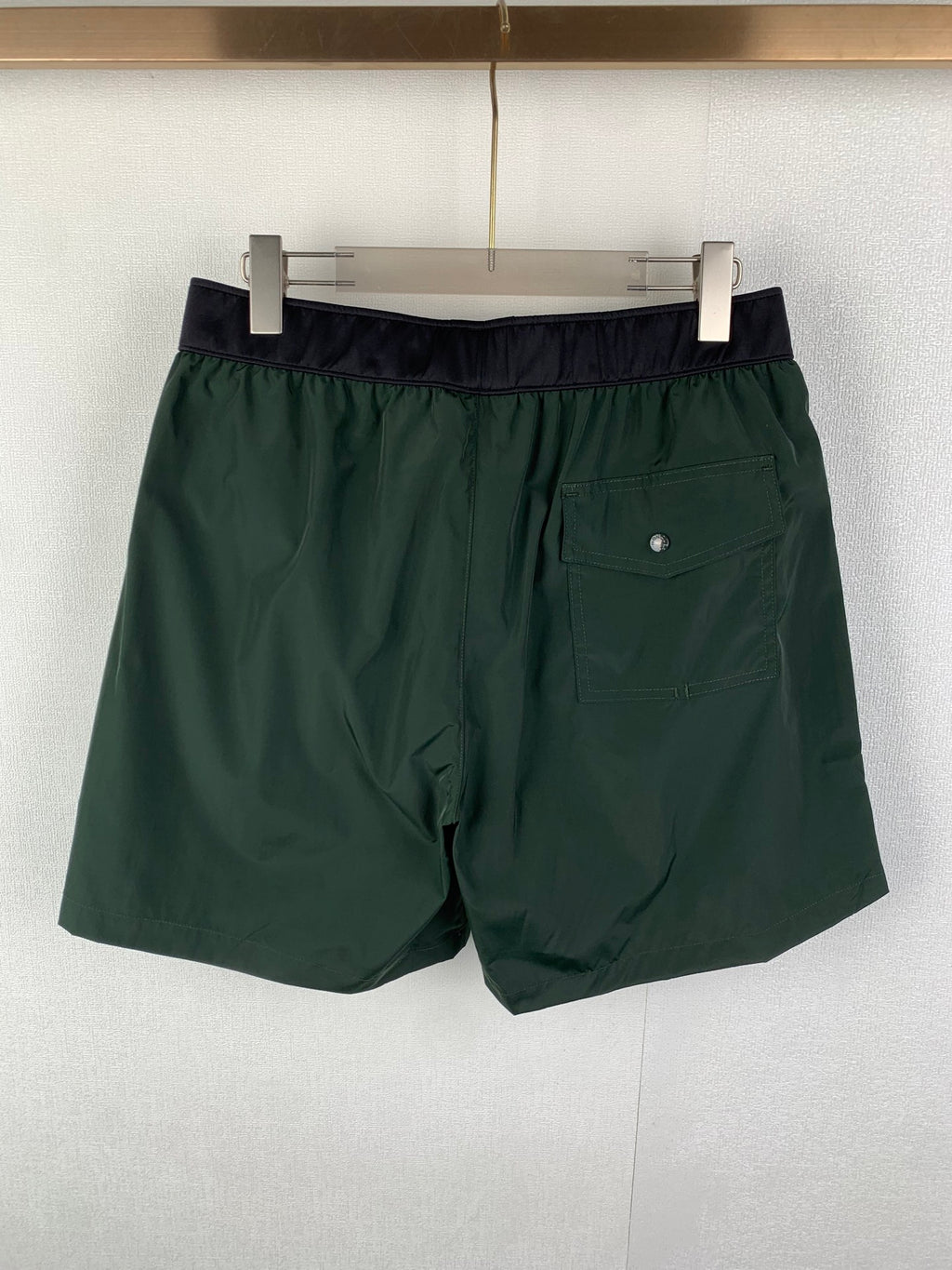 Moncler green shorts with dark waistband and side pocket detail