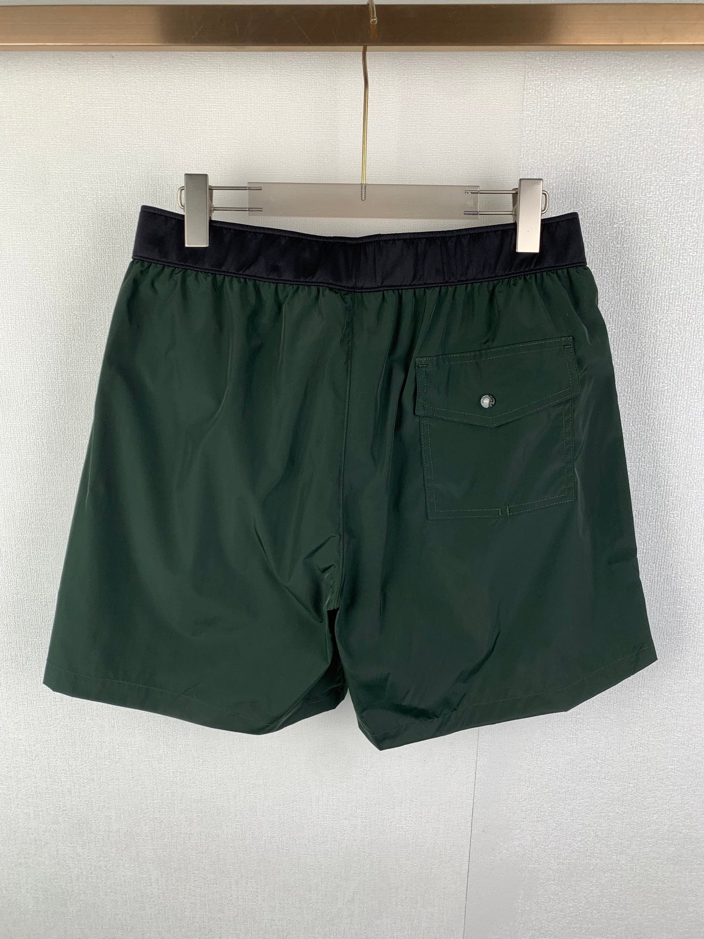 Moncler green shorts with dark waistband and side pocket detail