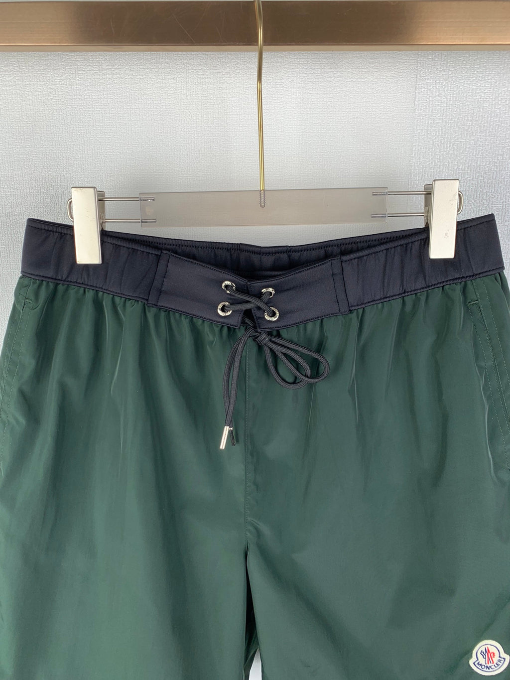 Moncler green drawstring shorts with dark waistband and front lace-up ties