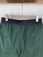 Moncler green shorts with dark waistband and front pocket detail
