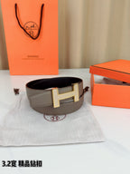Hermes belt with gray leather strap and gold-tone H buckle in a wide view