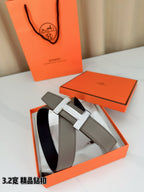 Hermes leather belt with gray strap and silver-tone H buckle, belt holes visible
