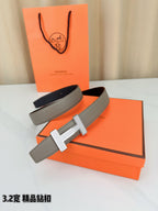 Hermes leather belt set with gray strap and silver-tone H buckle on orange boxes