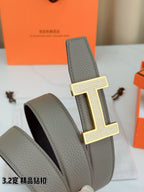 Hermes belt with gray leather strap and gold-tone H buckle on raised keeper