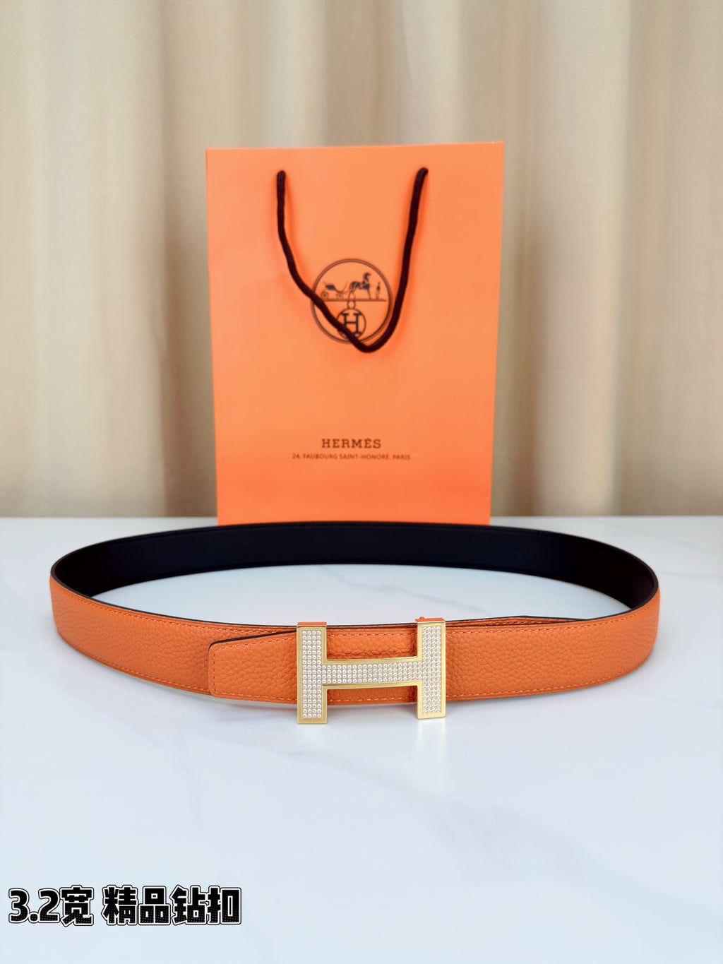 Hermes belt in orange textured leather with dark lining and silver H buckle