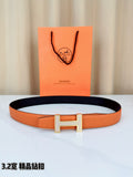 Hermes belt in orange textured leather with dark lining and silver H buckle