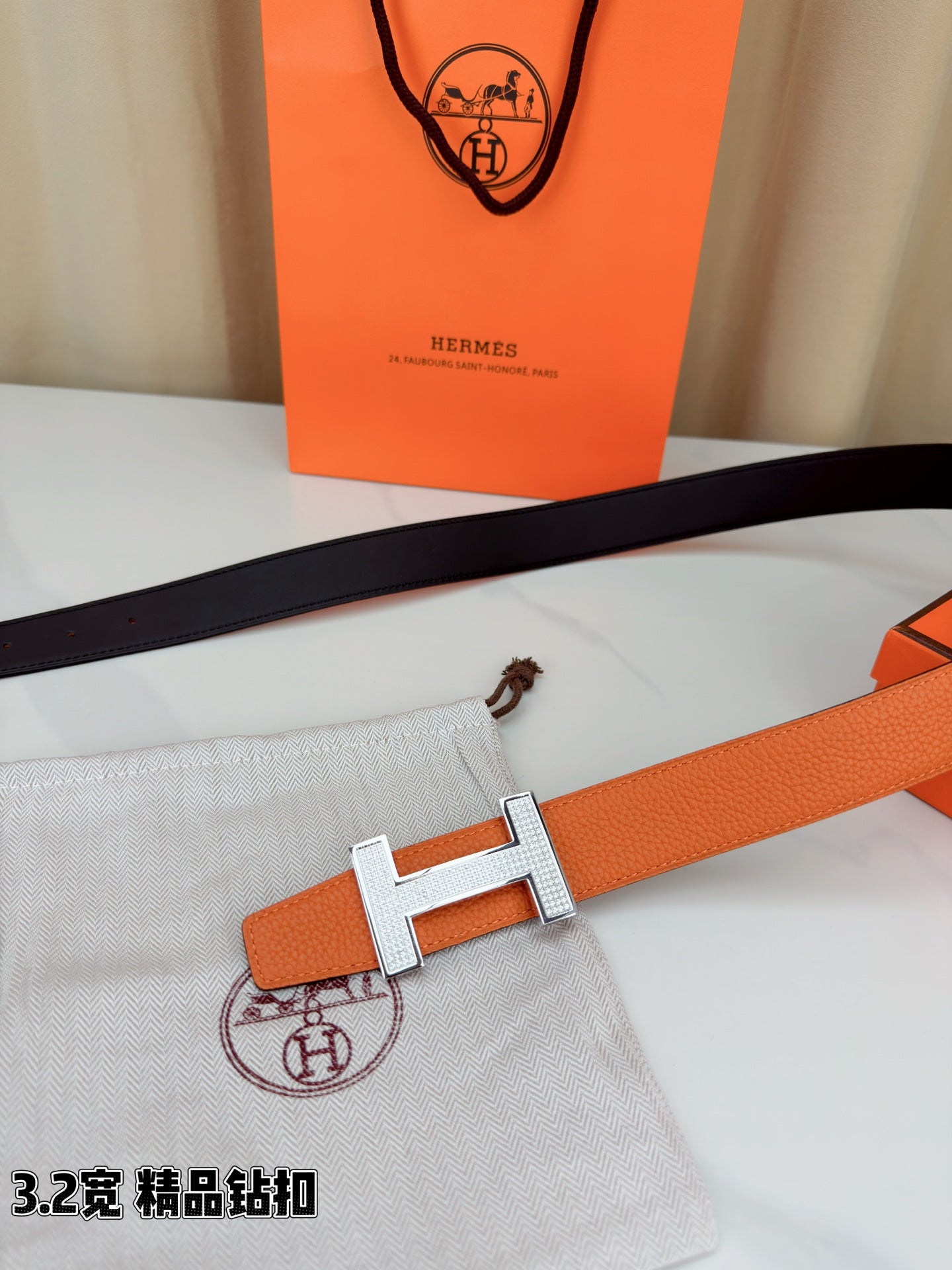 Hermes belt with orange strap and silver H buckle on dark inner band