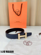 Blue leather belt with silver-tone H buckle and stitched leather texture
