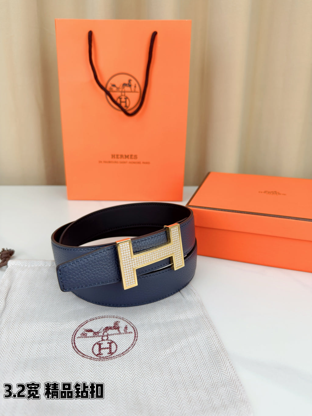 Blue leather belt with silver-tone H buckle and textured strap detail