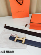 Blue leather belt with silver-tone H buckle and dark strap end with holes