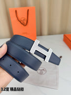 Blue leather belt with silver-tone H buckle and visible belt holes