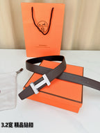 Dark brown leather belt with gold-tone H buckle and stitched texture