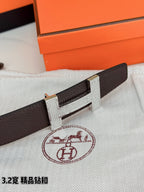 Dark brown leather belt with gold-tone H buckle in close detail