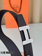 Hermes belt close-up: dark textured leather strap with silver-tone H buckle
