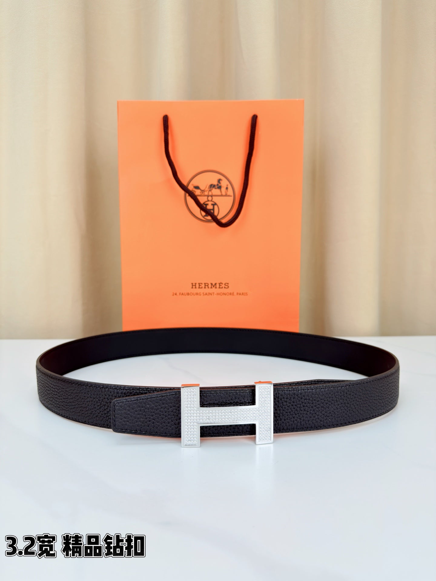 Hermes belt in dark textured leather with rectangular H buckle, silver-tone finish