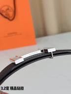 Hermes belt close-up of silver-tone buckle on dark leather strap
