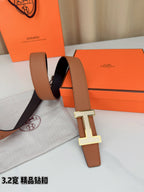 Tan leather belt with silver H buckle, shown over a black-lined section