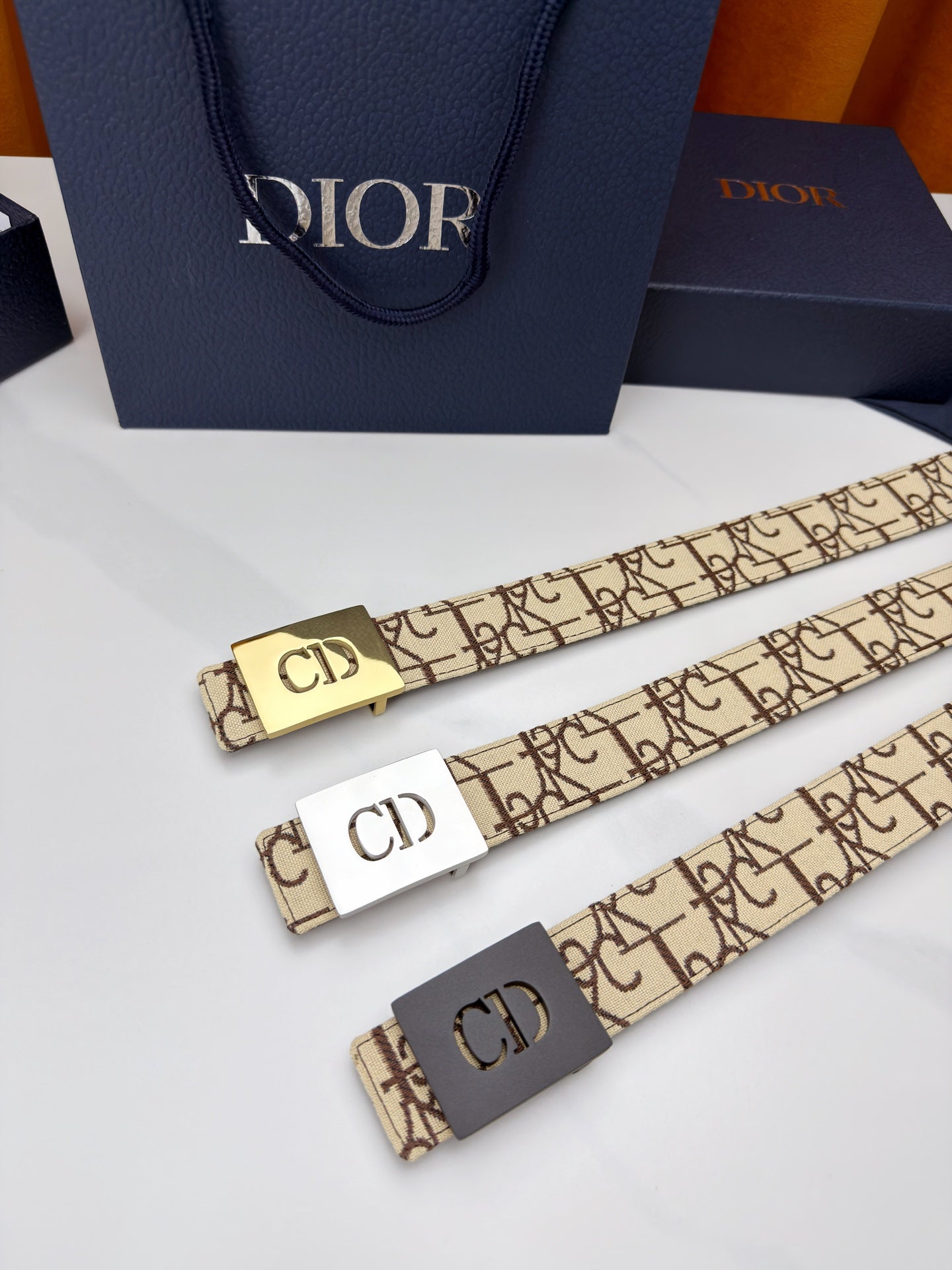 Dior belt set of three with beige monogram straps and gold-tone 'CD' buckles