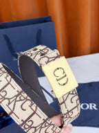 Dior belt close-up: beige monogram strap, dark edges, gold-tone 'CD' buckle