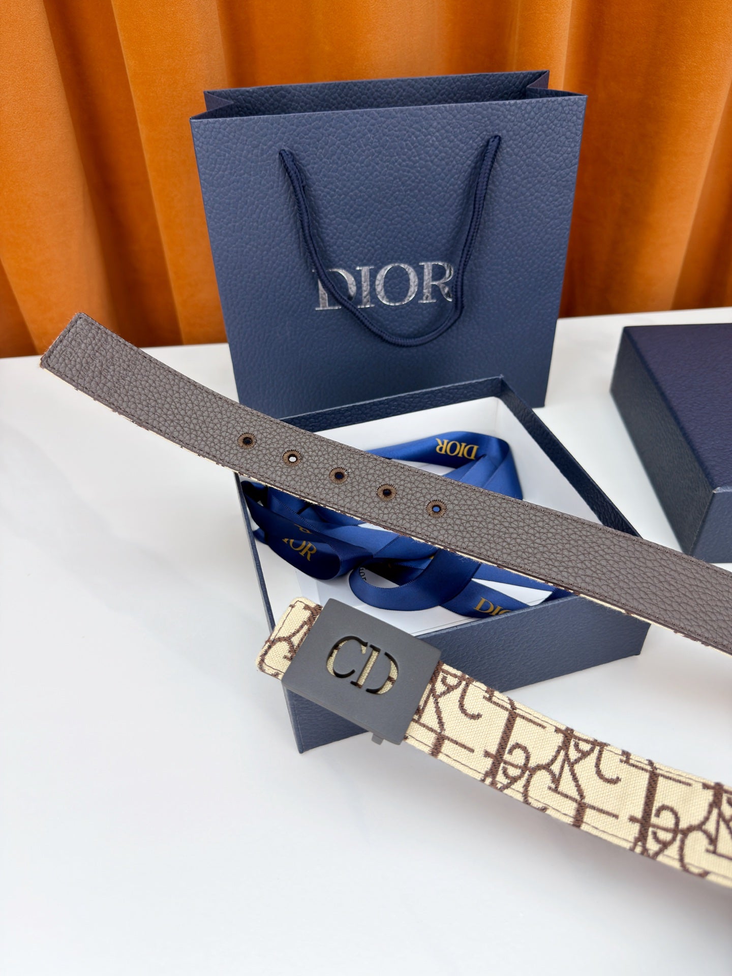 Dior belt with gray leather end, beige monogram strap, and CD buckle