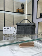 Black textured top-handle handbag with chain strap and gold-tone hardware, front view