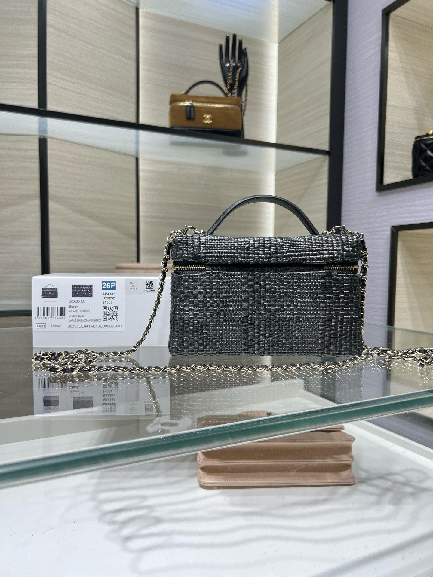 Black textured top-handle handbag with chain strap and gold-tone hardware, front view