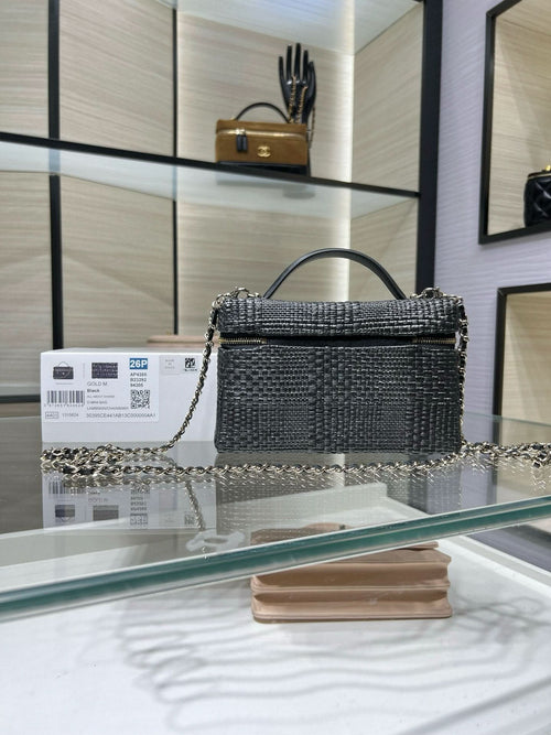 Black textured top-handle handbag with chain strap and gold-tone hardware, front view
