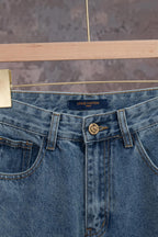 Blue denim jeans with Louis Vuitton logo on waistband, front button and belt loops.