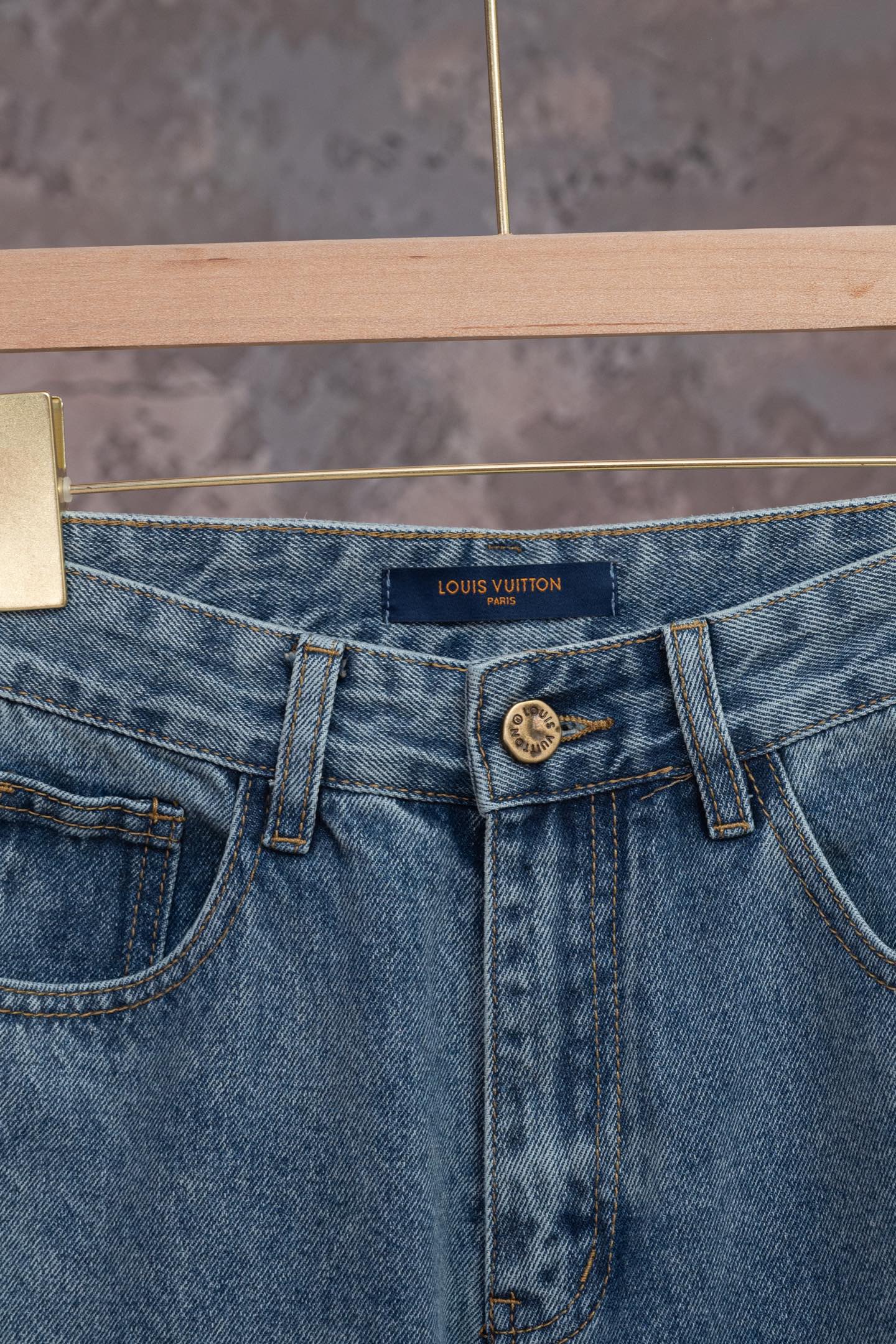 Blue denim jeans with Louis Vuitton logo on waistband, front button and belt loops.