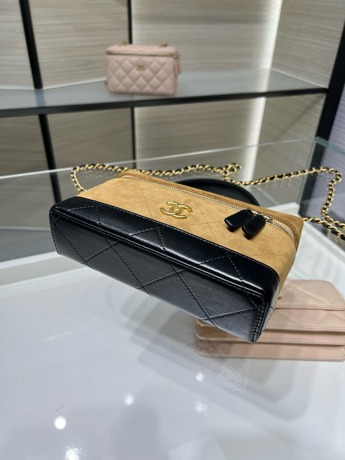 Black and gold Chanel shoulder bag with chain strap and quilted-style flap