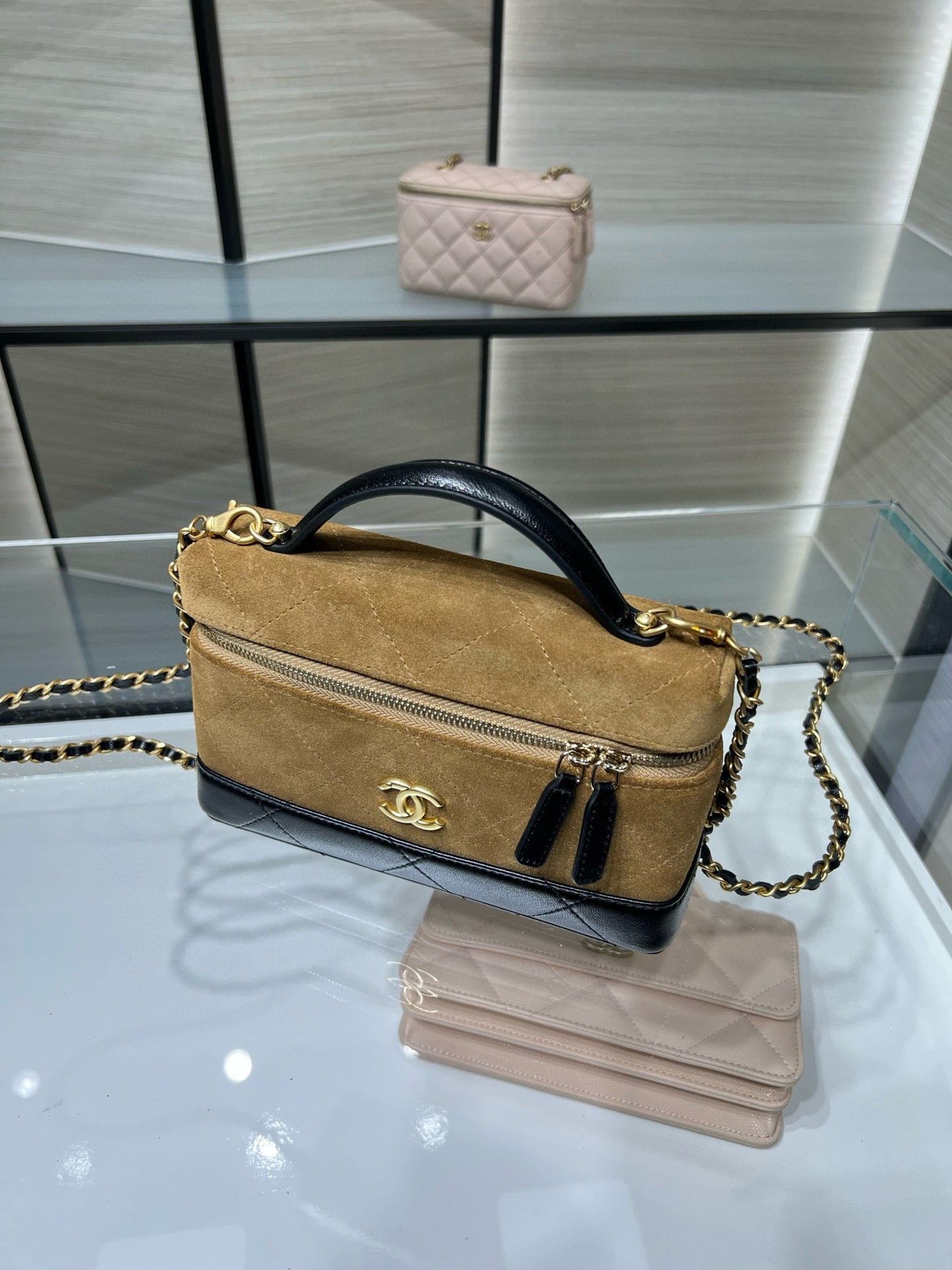Gold Chanel small top-handle bag with chain strap and front zipper pocket