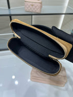 Open gold Chanel zip-top clutch with black interior and gold-tone zipper trim