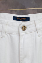 White denim pants waistband with Louis Vuitton logo patch and button