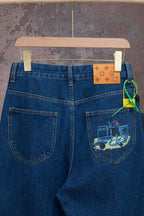 Blue denim jeans close-up with front pockets and embroidered graphic
