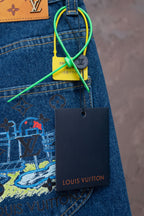 Blue denim jeans with back-pocket graphic and green string tag