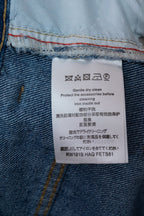 Denim jeans care label with ironing instructions and RW1818 HAGFETS81 code