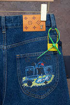 Blue denim jeans with colorful back-pocket graphic and hanging tag