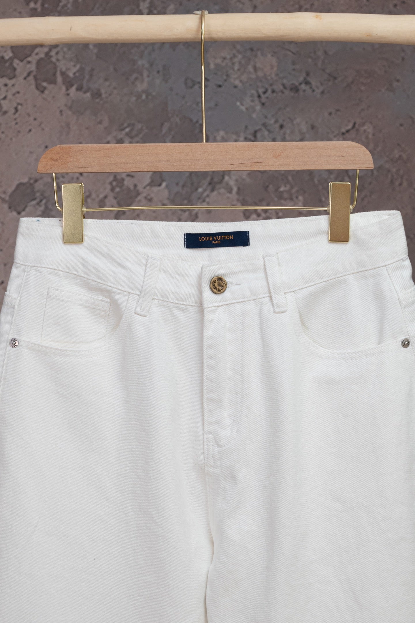 White Louis Vuitton pants front with belt loops, button fly and coin pocket