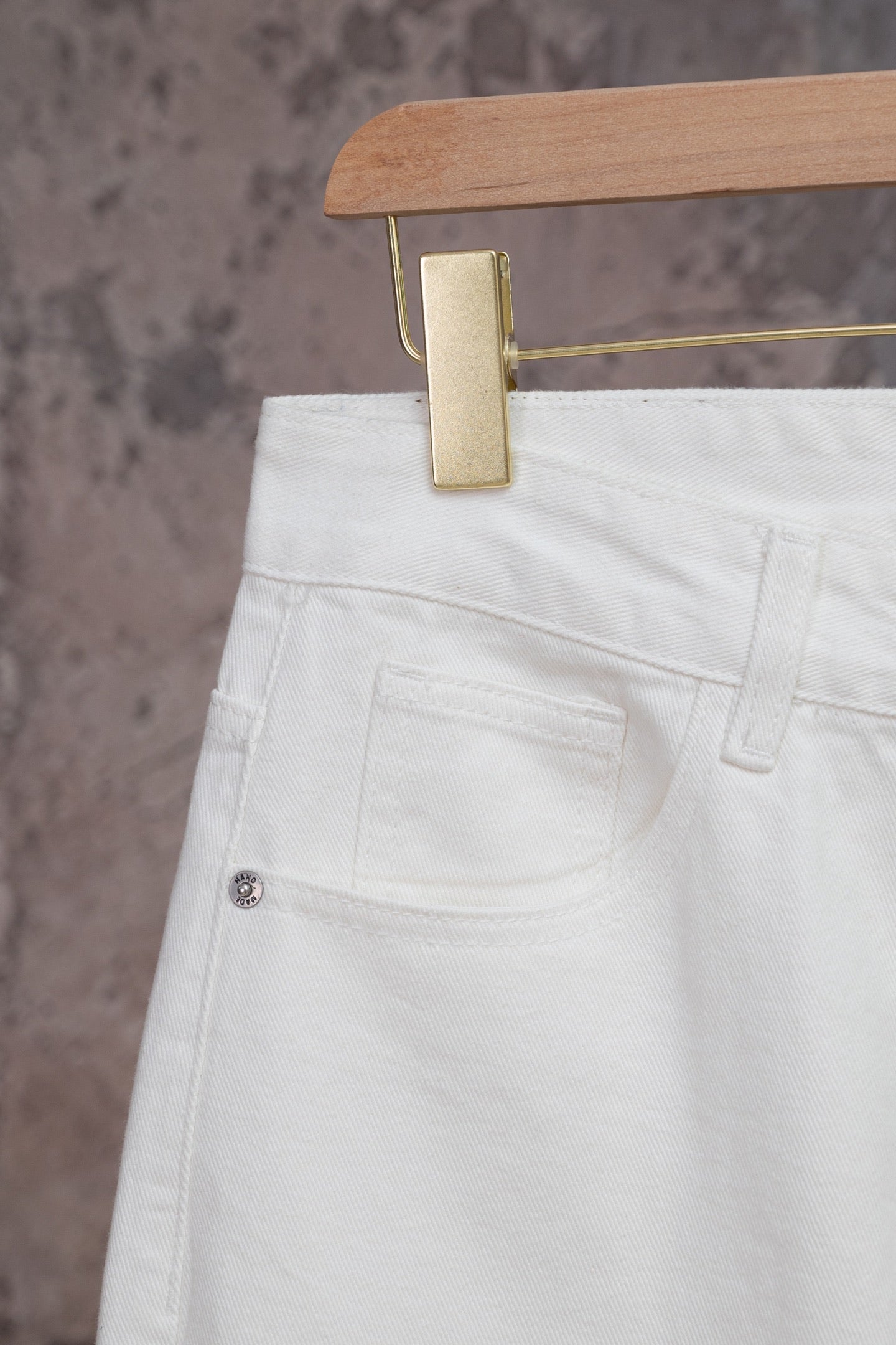 White Louis Vuitton pants close-up of side pocket and waistband seam