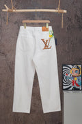 White Louis Vuitton pants on hanger with LV graphic patch on right pocket