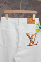 White Louis Vuitton pants with LV logo patch on front pocket and waistband tag