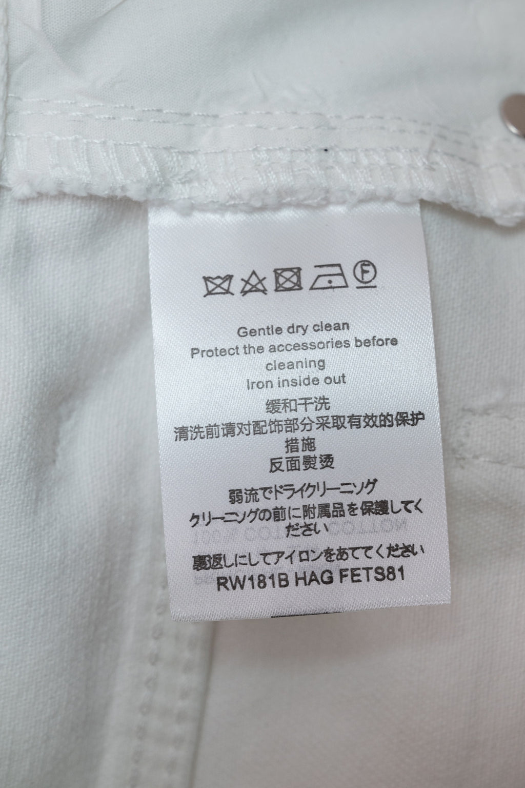 White Louis Vuitton pants care label on inner waistband