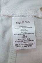 White Louis Vuitton pants care label on inner waistband