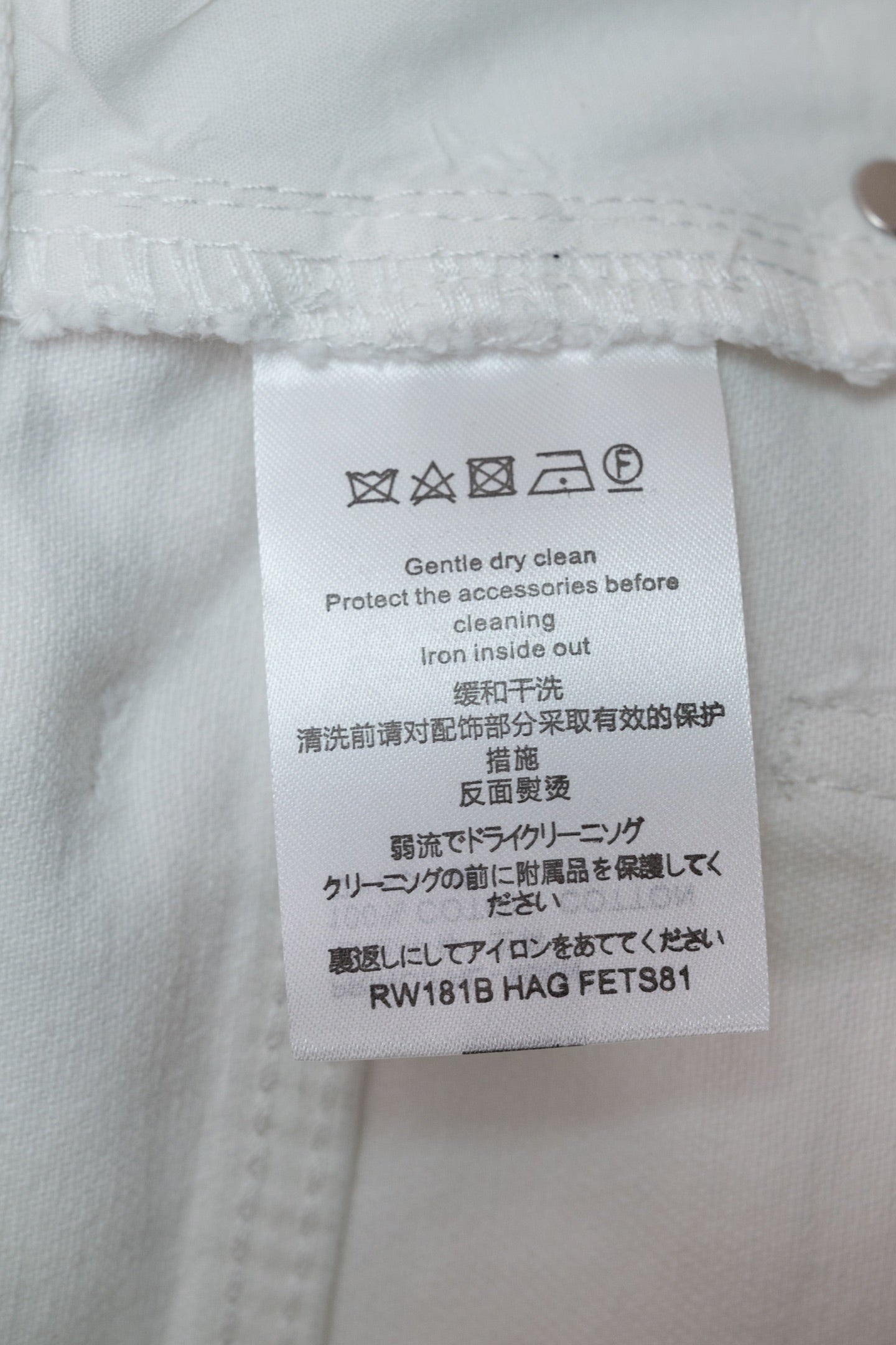 White Louis Vuitton pants care label on inner waistband